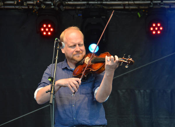 Auf der Konzertbühne des plattdeutschen Festivals spielt ein Mann Geige.