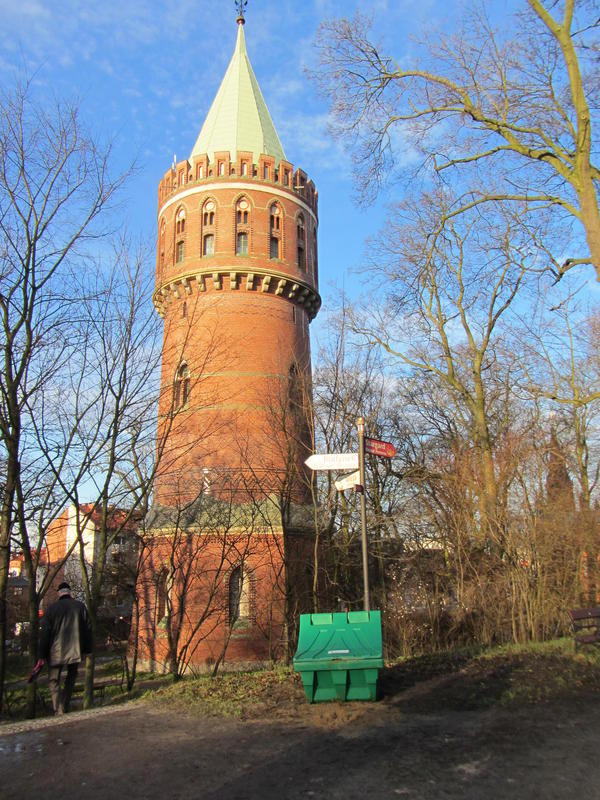 Der historische Turm ragt in den blauen Himmel.