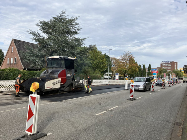 Bild vergr&ouml;&szlig;ern: Autos fahren an einer Stra&szlig;enbaustelle vorbei.