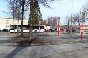 Ein weißer Linienbus steht an einem von mehreren Haltepunkten auf dem zentralen Busbahnof.